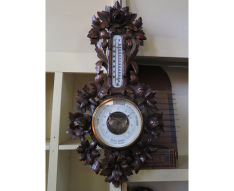 A Dutch Holosteril barometer by P. Romer Nijmegen with foliate carved surround, thermometer above wheel barometer - Height 76