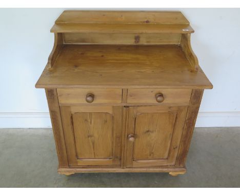 A 19th century pine base unit of two drawers over two doors with shaped upstand with shelf, stripped and waxed - 95cm x 84cm 