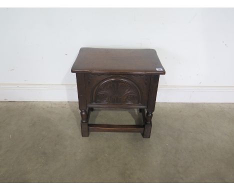 A carved oak box top stool - Height 47cm x Width 48cm x Depth 33cm 