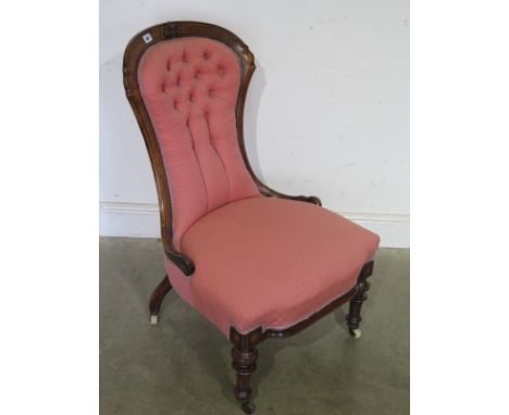 A Victorian walnut button back nursing chair
