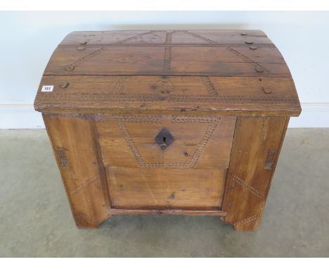 A very unusual 19th century dome-top pine trunk with decorative carving, with wood hinges and pegged joint construction - 64c