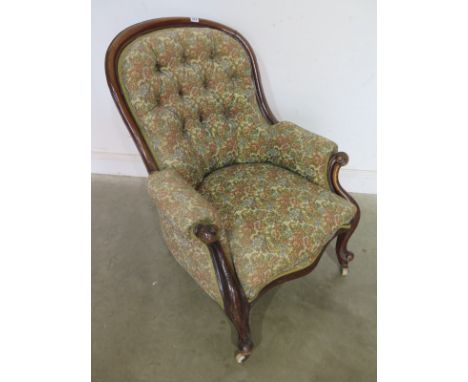 A Victorian walnut button back fireside chair