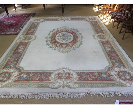 A large 20th century Chinese carpet with a cream ground and central medallion and foliate boarder - 4.2m x 3.08m
Condition re