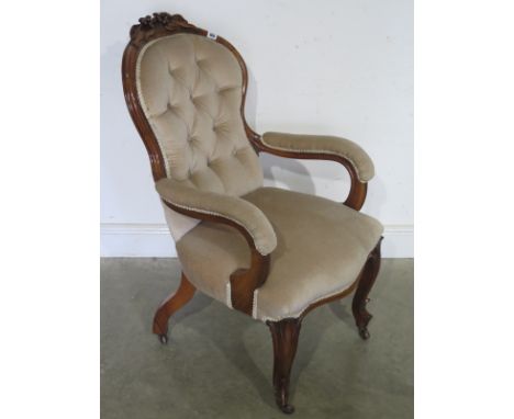 A Victorian walnut button back armchair