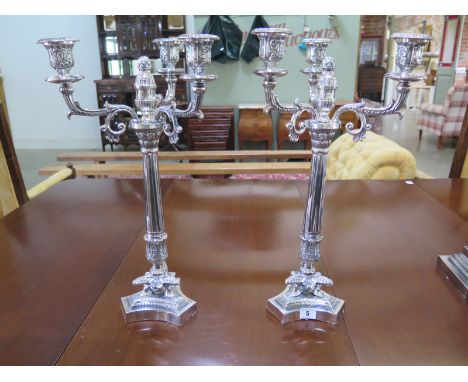 A pair of silver plated Empire style three light candelabra on triform bases - Height 53cm