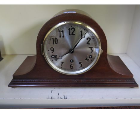 A mahogany eight day mantel clock with Westminster chimes in a mahogany case
Condition report:  Working with key 