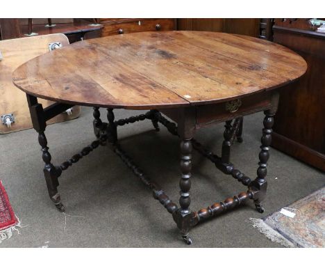 An 18th-century oak Gateleg Dining Table, with single drawer over bobbin supports and stretchers, 170cm by 145cm by 79cm