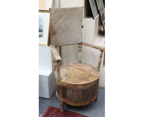 An African Hide Mounted Armchair, seat as a drum, 114cm highEstimate £80-120.