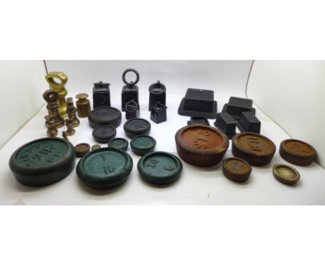 A collection of weights including bell weights and smaller balance scale weights 