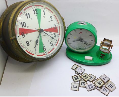 A Kelvin Hughes quartz clock and a Chinese clock with flip over calendar 