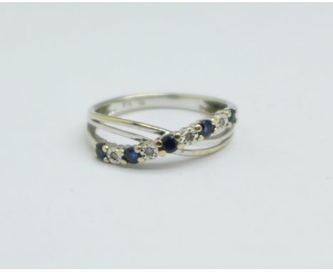 A 9ct white gold, five sapphire and four diamond crossover ring, 1.5g, K 