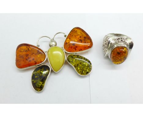 A large silver and amber butterfly brooch and a silver and amber ring, size R 