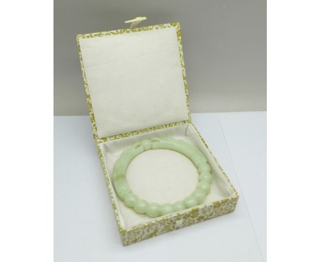 A Chinese carved jade bangle, with box 