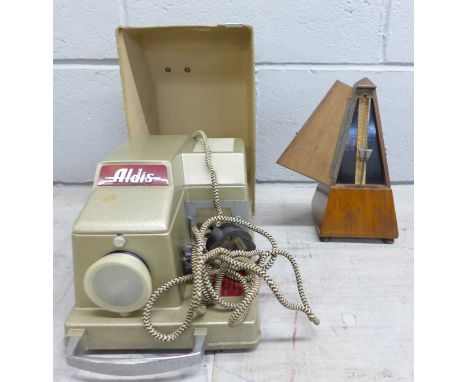 A vintage Maelzel metronome and an Aldis 35mm slide projector **PLEASE NOTE THIS LOT IS NOT ELIGIBLE FOR POSTING AND PACKING*