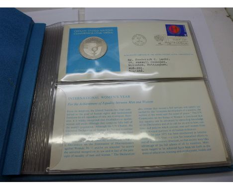 An album of seven First Edition Proof Sterling Silver coin covers, Official United Nations Commemorative Medals 