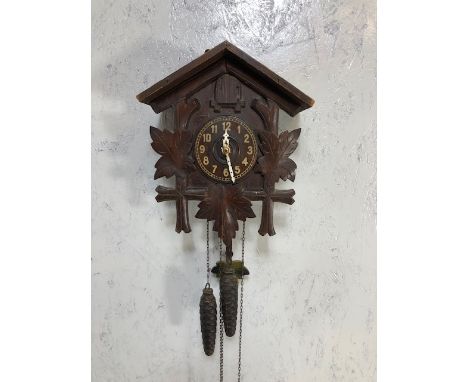 Black forest style wooden cuckoo clock with pine cone weights and pendulum 
