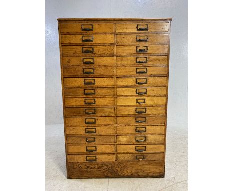 Light oak specimen cabinet with two flights of 14 narrow drawers with metal cup handles with aperture for labels, approx 76cm