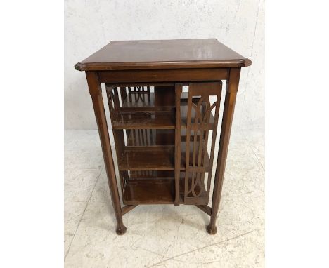 Large table/canterbury on octagonal legs with rotating book shelf to centre, approx 60cm x 60cm x 91cm tall 