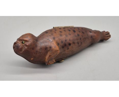 Unusual antique hand carved wood seal containing a smaller seal- possibly smoking pipe. Fitted with glass eyes. [16cm length]