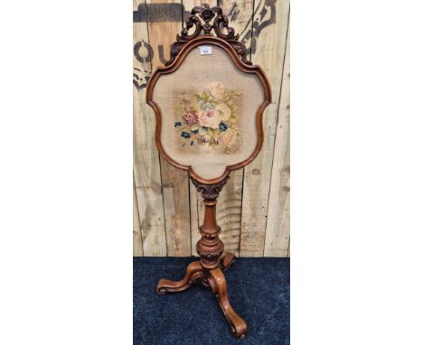19th century Mahogany pole screen for fire. Shaped screen having needlework tapestry insert. Carved column leading to three s