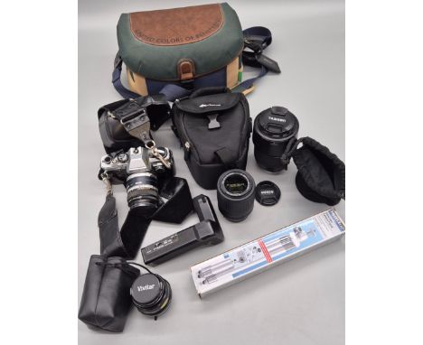 A collection of camera lenses &amp; Olympus OM 10 model camera; Nikkor DX lens, Tamron camera lens &amp; other items