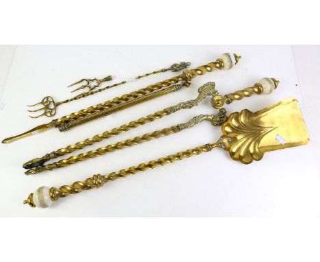 Set of brass fire irons comprising tongs, shovel and poker and a non-matching toasting fork and part of a fender of scrolling