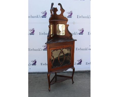 Late Victorian carved walnut corner cabinet, the shaped top with shelf and mirrored back over a glazed door on cabriole legs 