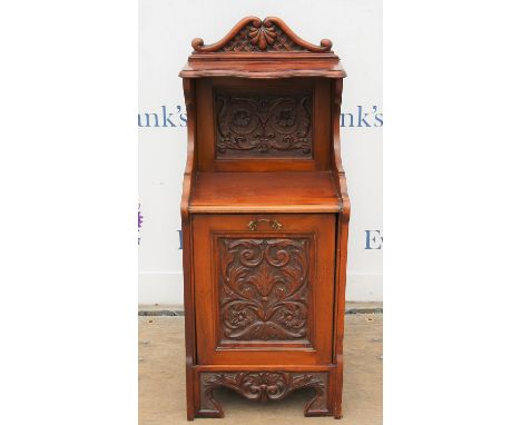 Late Victorian carved mahogany coal purdonium, the raised top with shaped shelf and carved panel, over a fall front, carved s