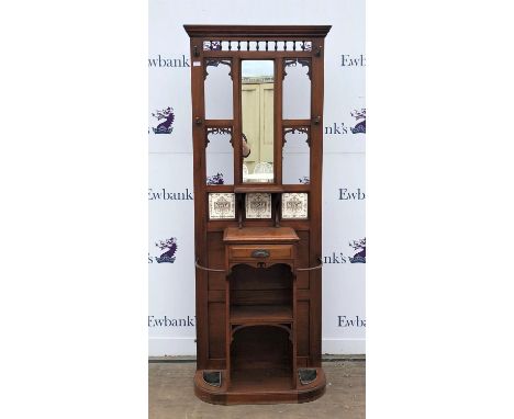 Early 20th century walnut hall stand, the mirrored and tiled back with shelf, over a drawer and open shelves flanked by umbre