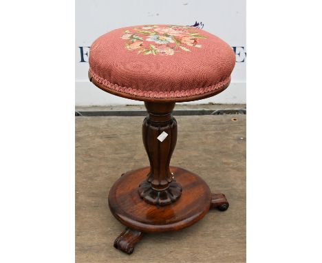 Mid Victorian rosewood piano stool, the circular adjustable seat  on a lobed stem and circular base with scroll feet