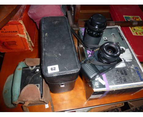Canon T50 with two lenses, a Canon Motor Zoom *8 movie camera, and a Box Brownie