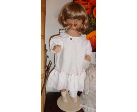Vintage composite doll on stand with internal wind-up speaker (not working)