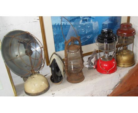 Two Tilley lamps, a Tilley heater, an old gas iron, and a hurricane lamp