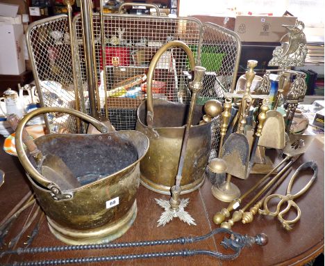 Two brass coal scuttles, several sets of fire-irons, a brass firescreen, and a quantity of wine glasses