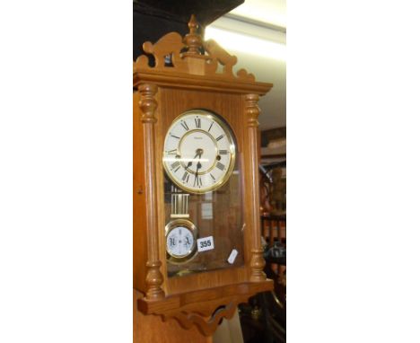 Wall clock in light oak case