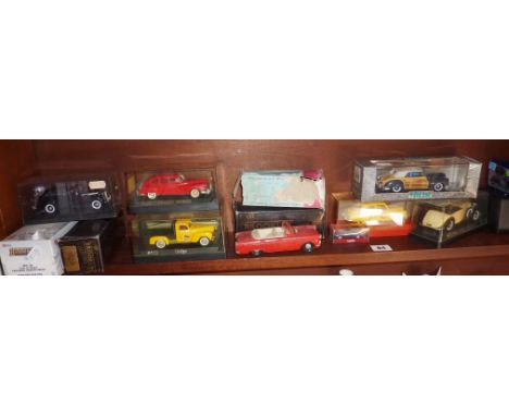 Shelf of diecast vehicles, some American, many boxed