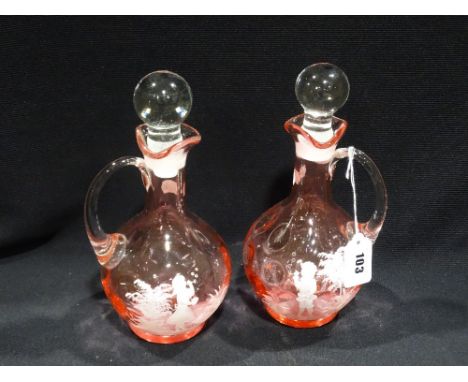     A Pair Of Cranberry Tinted Jugs With Stoppers With Mary Gregory Style Enamel Decoration                                  