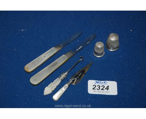 Two silver Thimbles, two silver and mother of pearl folding fruit Knives, a Silver and mother of pearl page Marker and a smal