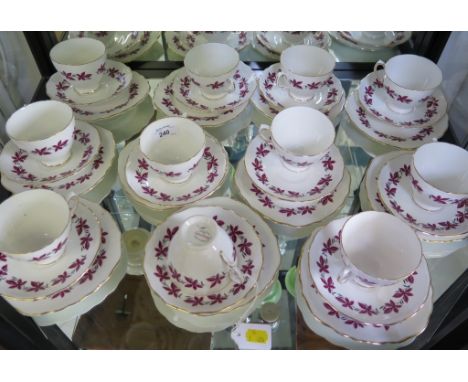 A Colclough china tea service, comprising cups, saucers and side plates for eleven place settings, decorated with bands of re