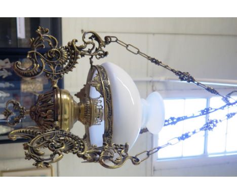 A brass ceiling light, in the form of an oil lamp with white glass dome and acanthus cast supports, 37cm diameter 