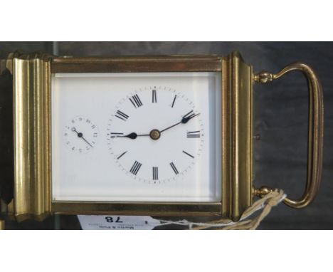 A brass case carriage clock, with fluted handle over an enamel dial with alarm subsidiary enclosed by a moulded frame, the tw