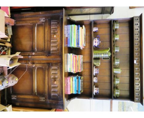 An oak dresser and rack, the fluted cornice over two shelves, the base with two fluted frieze drawers above panelled doors on