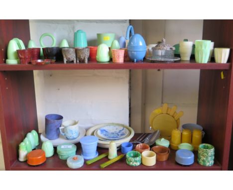 A variety of vintage plastics, including egg cups, condiment sets, plates and saucers