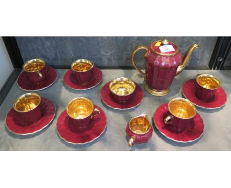 A Wade coffee service, with crimson fluted sides and gilded interiors, six cups and saucers, coffee pot, sugar bowl and sauce
