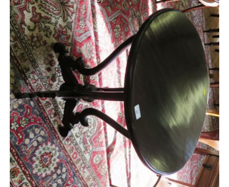 A Victorian style stained wood occasional table, the circular top over four scroll supports and legs with central finial, 60c