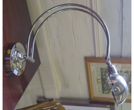 An Art Deco style nickel plated angle poise lamp, with C-shape support on circular base