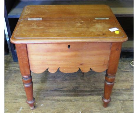 A 19th century mahogany box stool, the hinged rectangular top with moulded edge over a fret carved frieze on turned tapering 