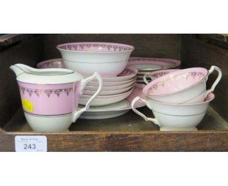 A Czechoslovakian pink and gilt tea service, for six plate settlings, with tea cups, saucers, plates, serving plate, jug and 