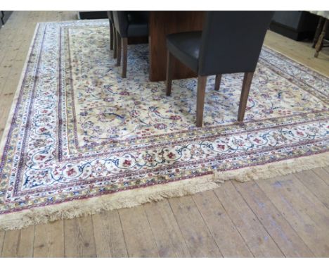 A Kashmir carpet of sharbass design, with ivory medallion on a gold field with foliate and floral scrolls within an ivory bor