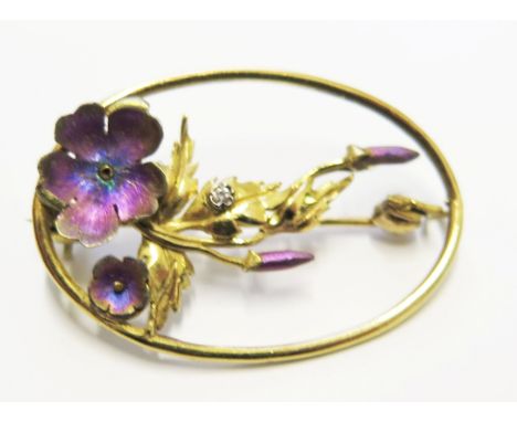 A gold coloured metal flower brooch set with a small diamond and enamel flowers